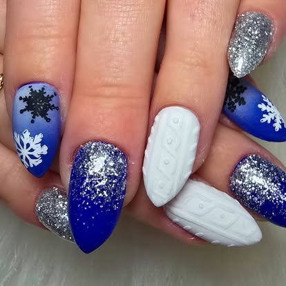 Blue and white winter nails with snowflakes, knit texture, and silver glitter